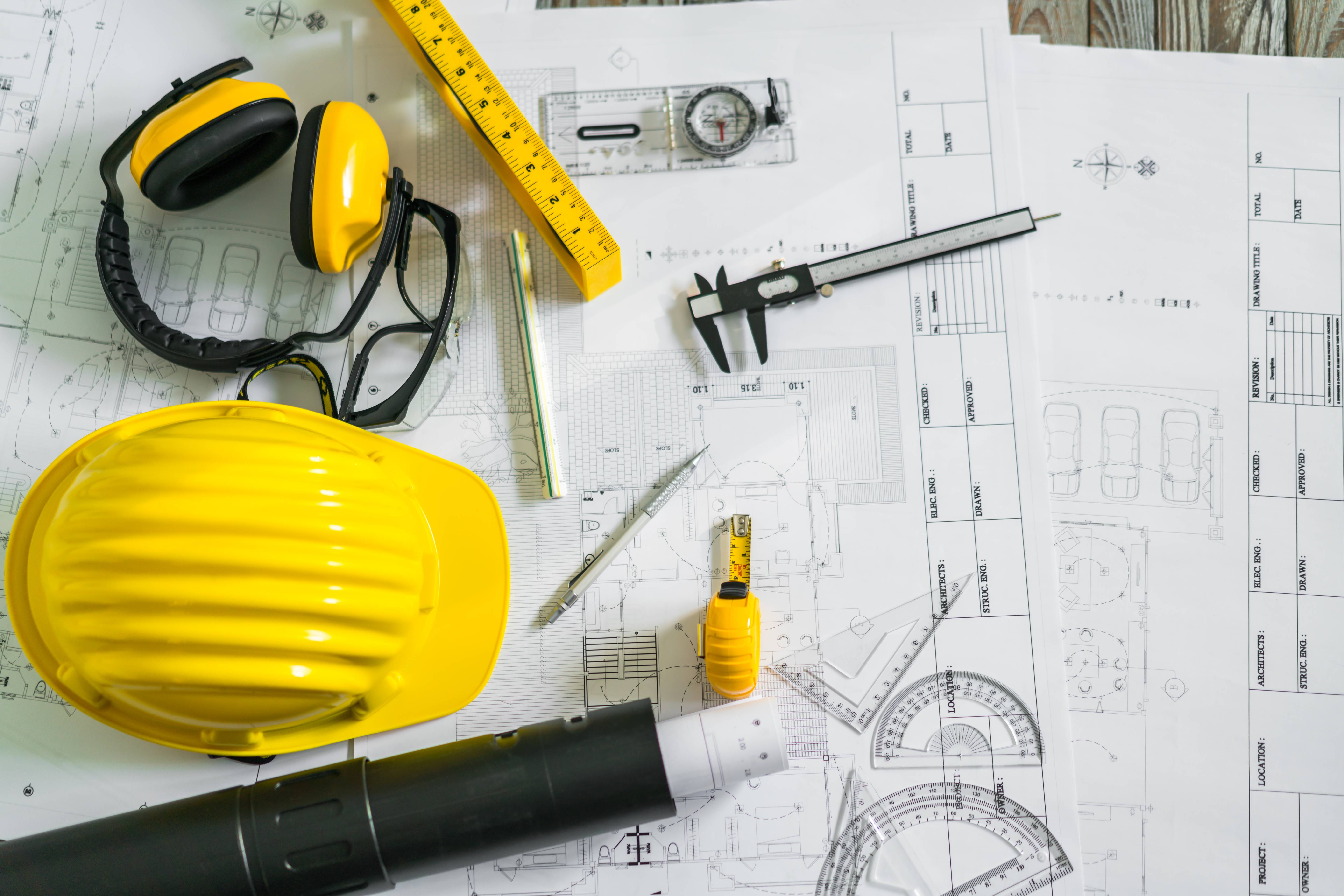 construction-plans-with-helmet-drawing-tools-blueprints (1)